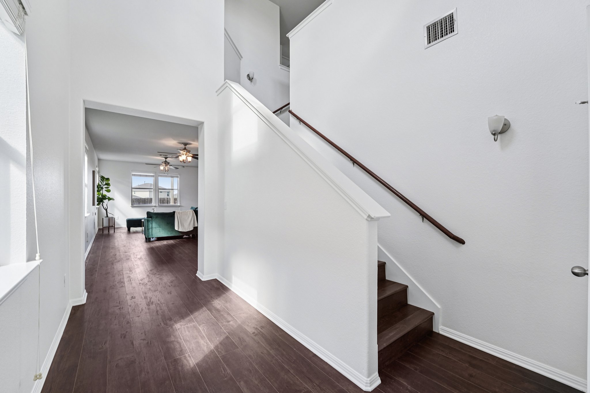 288 Triumph Road Buda, TX 78610 - Photo 8 of 19 a view of a hallway with wooden floor and staircase