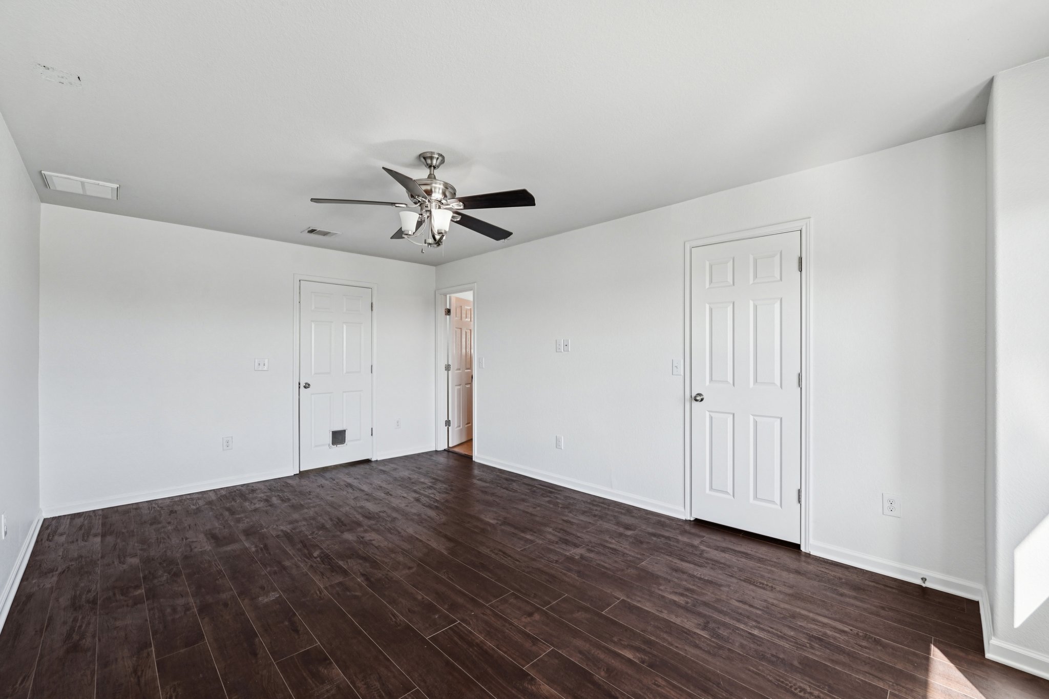 288 Triumph Road Buda, TX 78610 - Photo 10 of 19 a view of an empty room with wooden floor