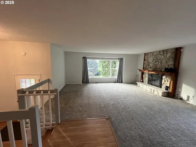 a view of livingroom with furniture flat screen tv and windows