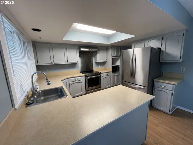 a kitchen with refrigerator and microwave