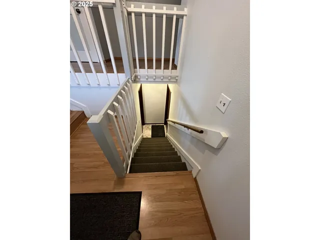 a view of staircase with black and white wall
