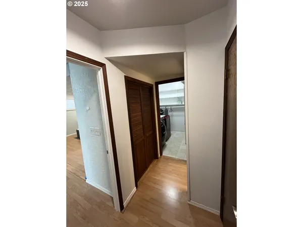 a view of a hallway with wooden floor