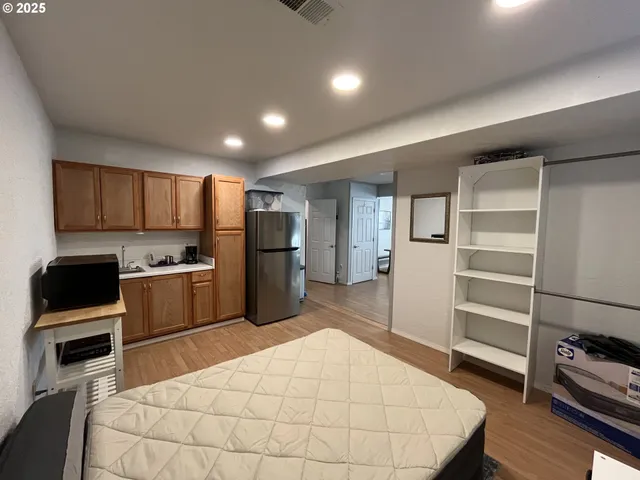 a kitchen with a refrigerator and a stove top oven