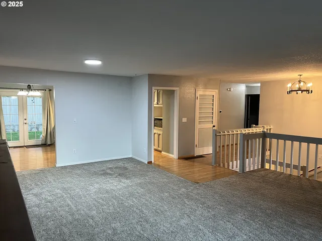 an empty room with mirror and a sink