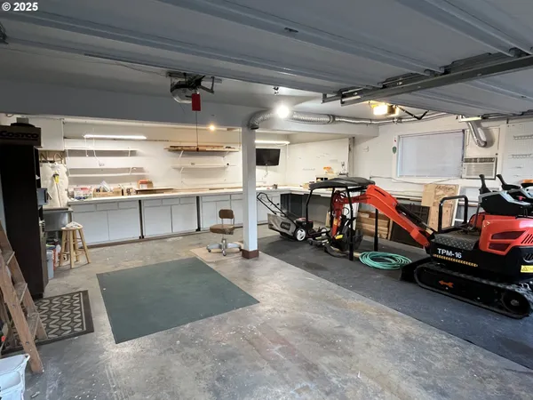 a view of a garage with a white car parked