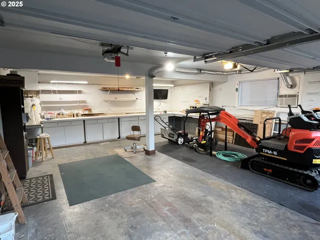 a view of a garage with a white car parked