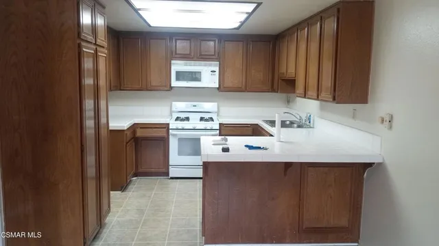 a utility room with cabinets washer and dryer