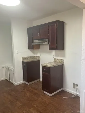 a kitchen with cabinets and white appliances