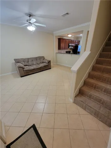 a living room with furniture and a chandelier