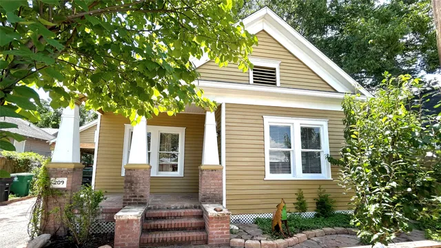 a view of a house with a tree