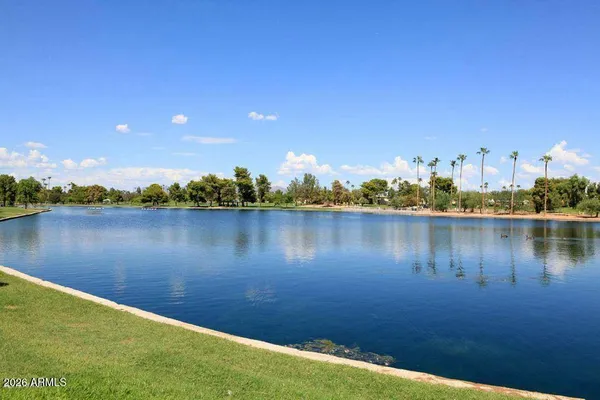 a view of a lake with houses in the background
