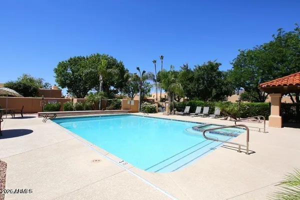 a view of a swimming pool with chairs
