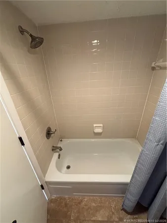 a bathroom with a tub and a shower
