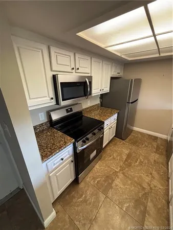 a kitchen with stainless steel appliances a stove a microwave and a refrigerator
