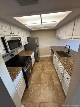 a kitchen with a stove and a refrigerator