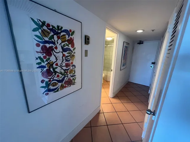 view of a hallway with wooden floor and a potted plant