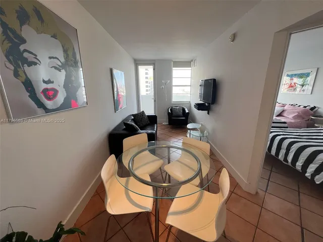 a dining room with furniture and a window