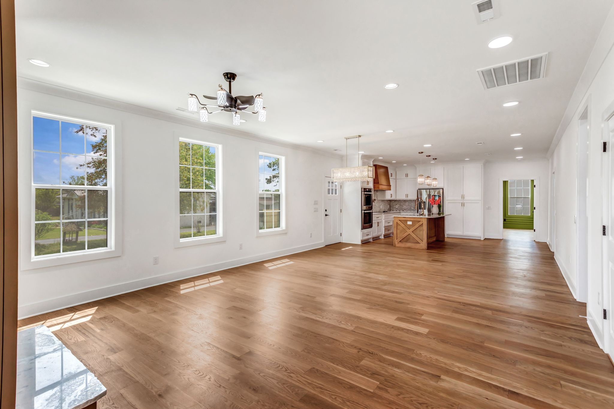107 Shady Street Summertown, TN 38483 - Photo 7 of 31 an empty room with wooden floor and windows
