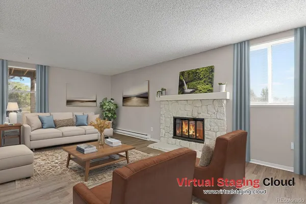 a living room with furniture and a fireplace