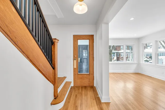 a view of an entryway with wooden floor and stairs