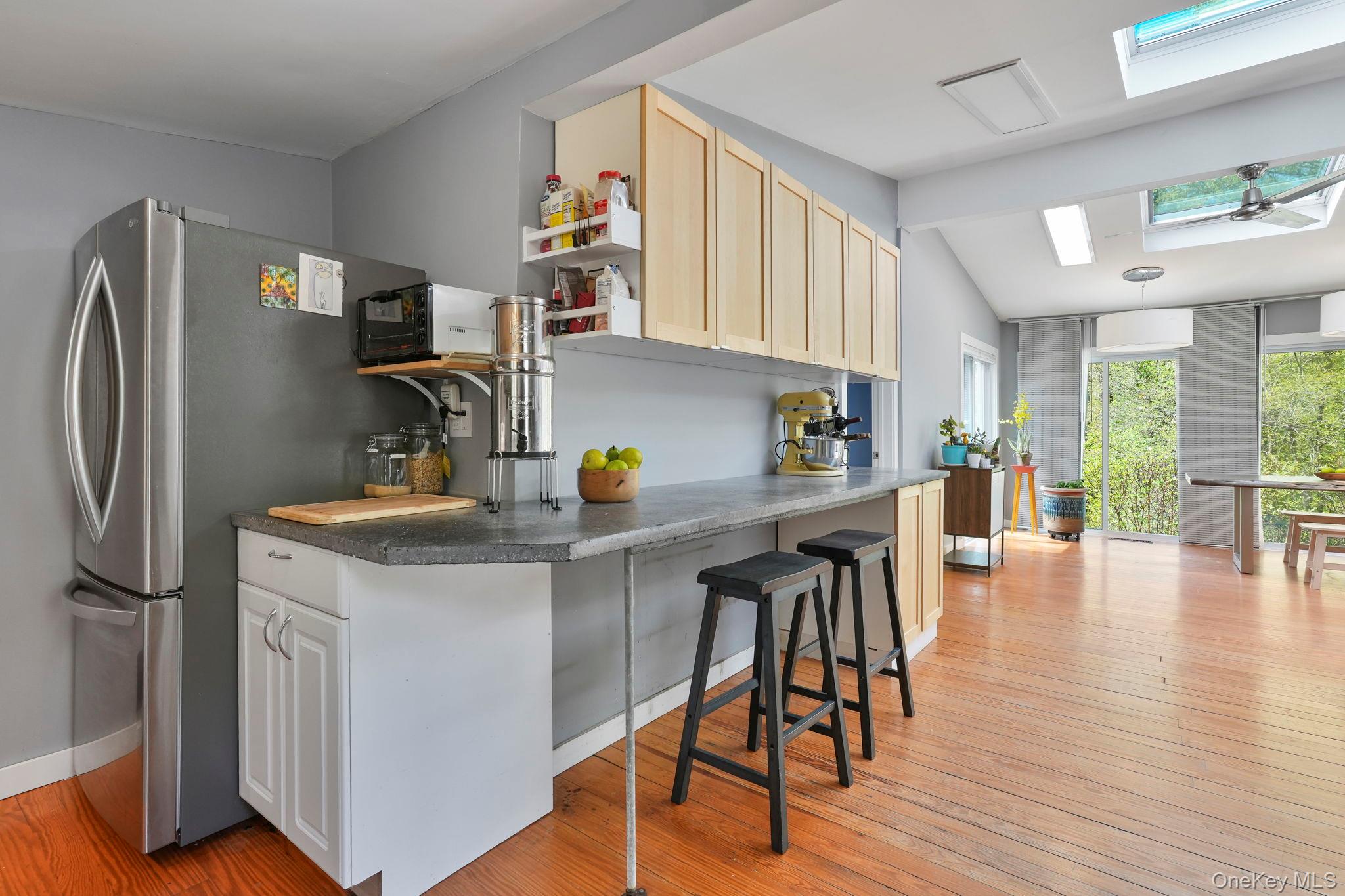 44 Tompkins Road Carmel, NY 10512 - Photo 6 of 31 a kitchen with stainless steel appliances granite countertop a refrigerator a sink a stove and island with wooden floor