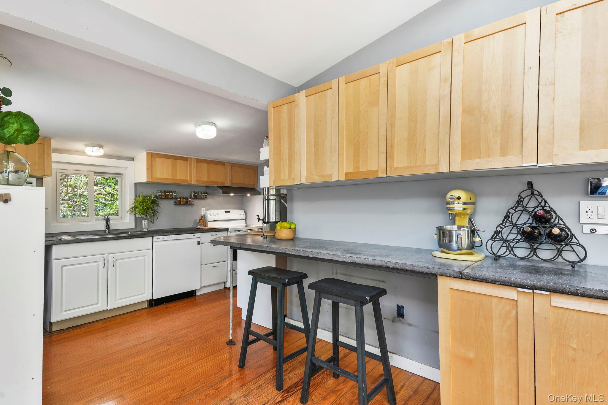 44 Tompkins Road Carmel, NY 10512 - Photo 7 of 31 a kitchen with stainless steel appliances granite countertop wooden cabinets a stove top oven a sink and dishwasher
