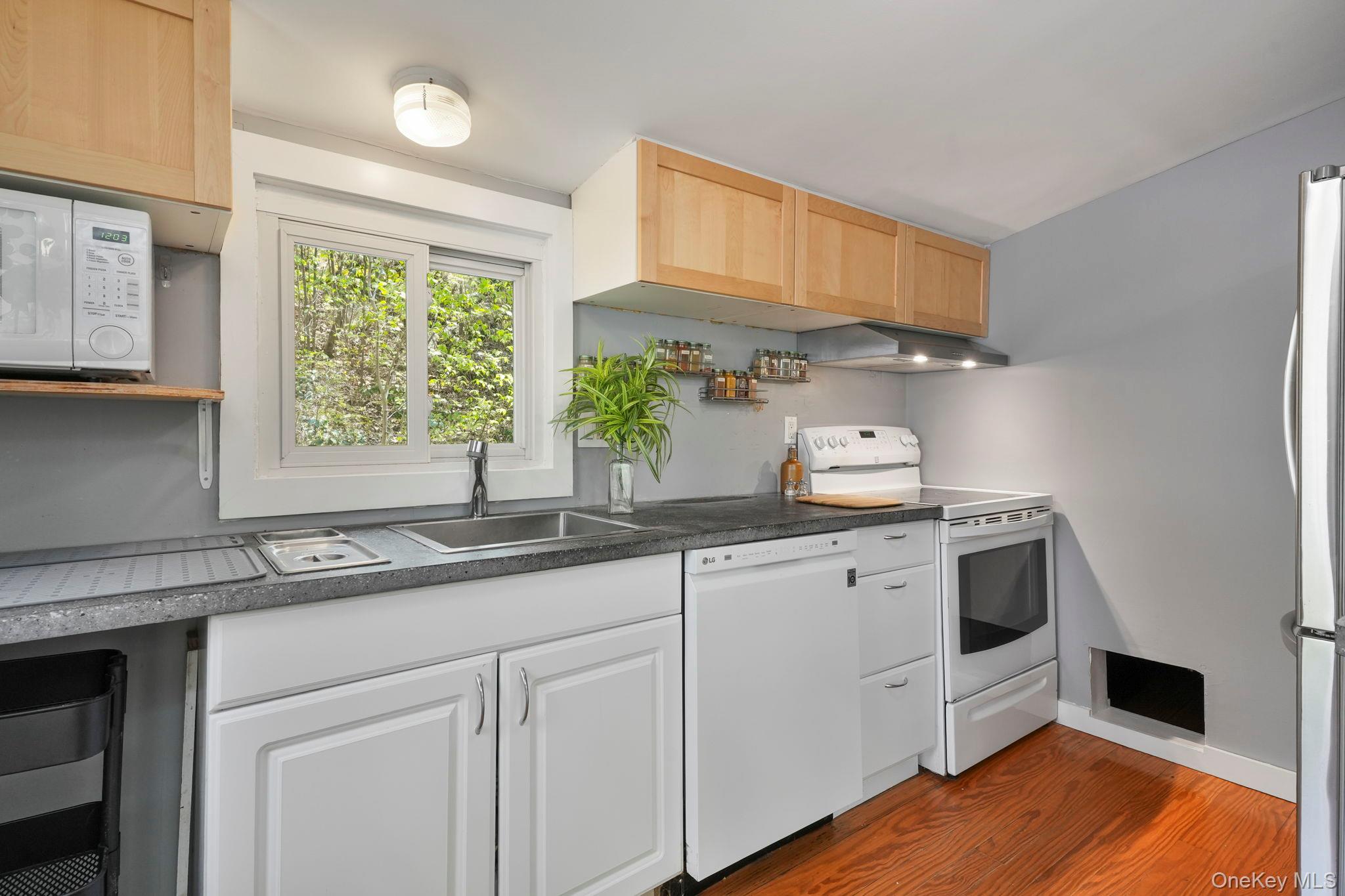 44 Tompkins Road Carmel, NY 10512 - Photo 8 of 31 a kitchen with granite countertop white cabinets and white appliances