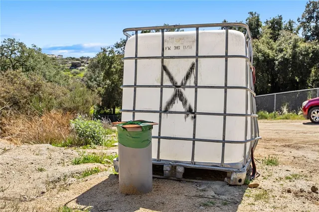 a view of a dry yard with mountains in the background
