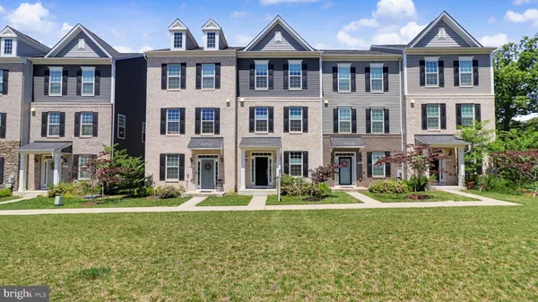 a front view of a residential apartment building with a yard