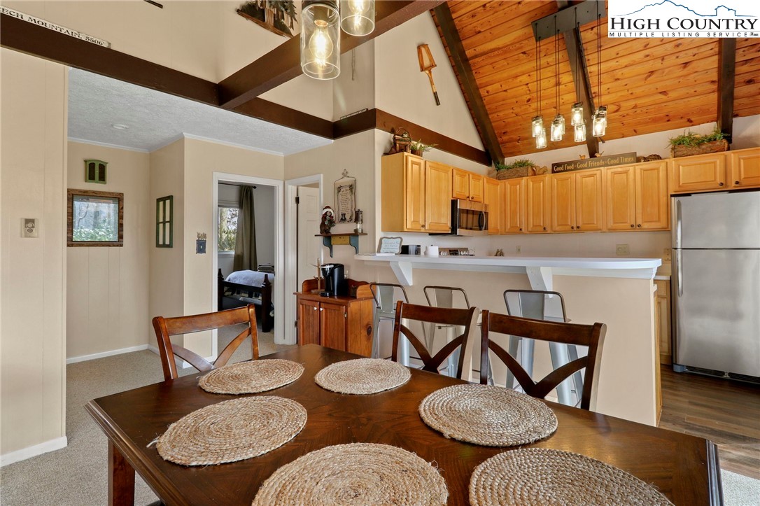 835 Pine Ridge Road Beech Mountain, NC 28604 - Photo 5 of 45 a view of a dining room with furniture