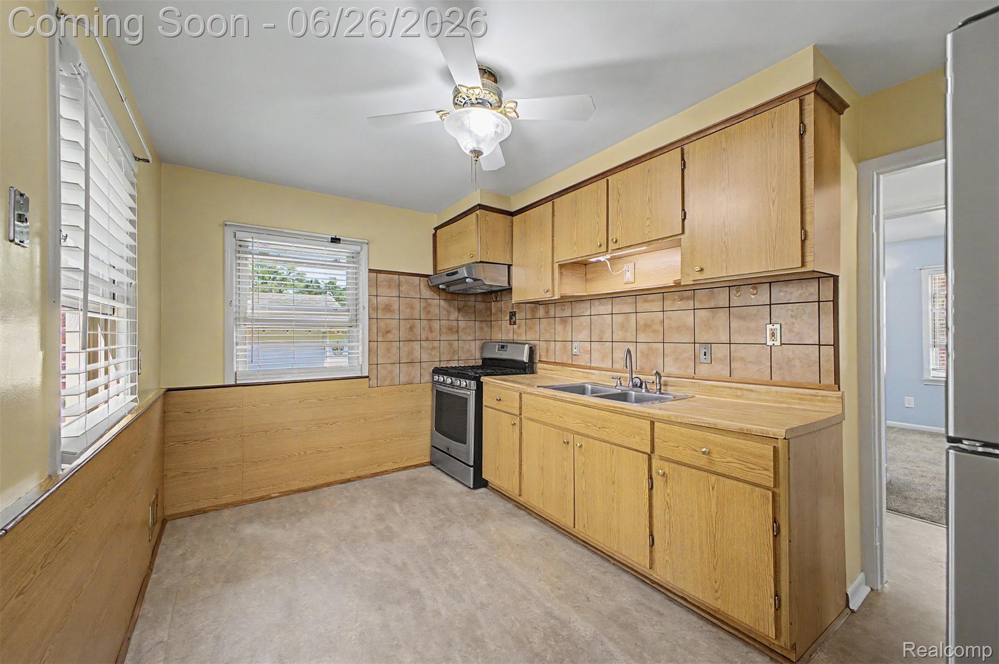 2216 Banner Street Dearborn, MI 48124 - Photo 14 of 34 Kitchen with light wood-finish cabinetry, tile backsplash, and a stainless steel range