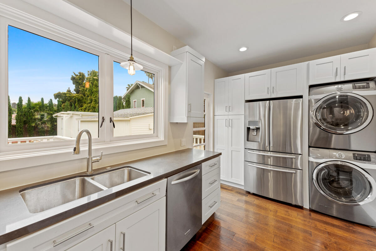 1309 Castillo Street Santa Barbara, CA 93101 - Photo 21 of 41 a kitchen with stainless steel appliances granite countertop a sink a stove a refrigerator and cabinets with wooden floor