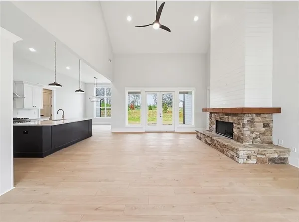 a spacious bathroom with a double vanity sink a toilet and a shower