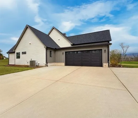 a view of an empty room with a fireplace and a window