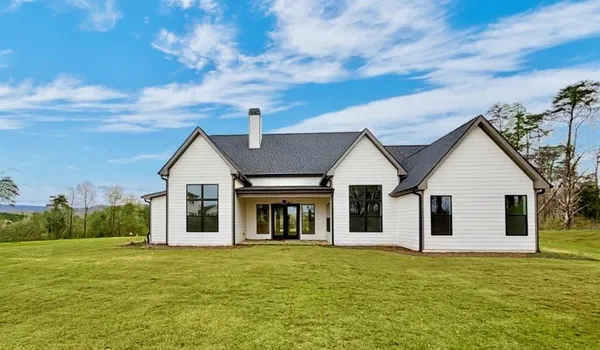 a kitchen with stainless steel appliances granite countertop a stove and a white cabinets