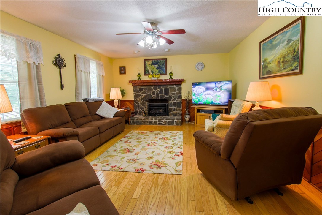 581 North Fork New River Road Lansing, NC 28643 - Photo 11 of 44 a living room with furniture a fireplace and a flat screen tv