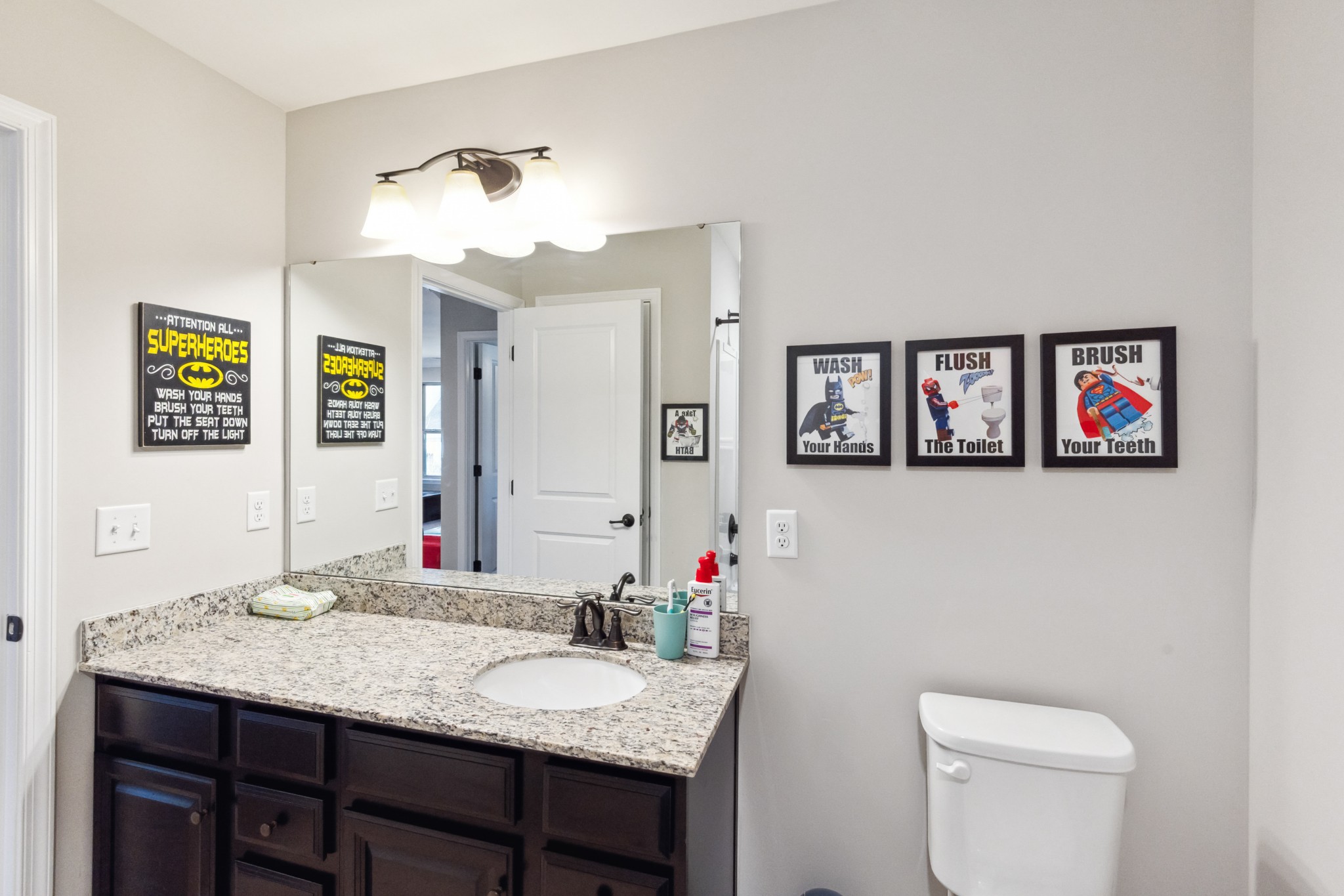 6820 Falls Ridge Lane College Grove, TN 37046 - Photo 32 of 46 a bathroom with a granite countertop sink a toilet and a mirror