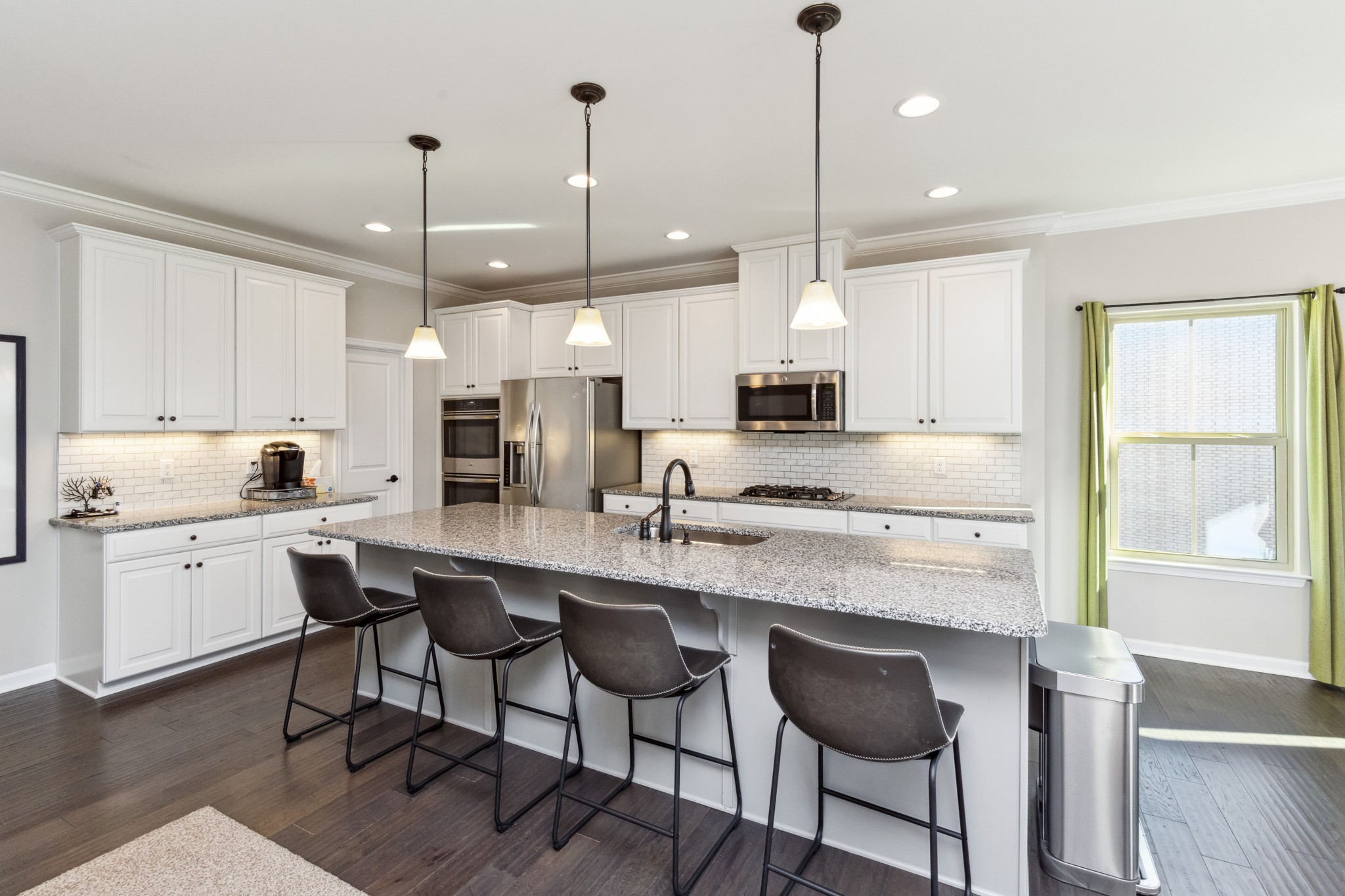 6820 Falls Ridge Lane College Grove, TN 37046 - Photo 6 of 46 a kitchen with stainless steel appliances granite countertop a stove a sink a oven a refrigerator a island and chairs with wooden floor
