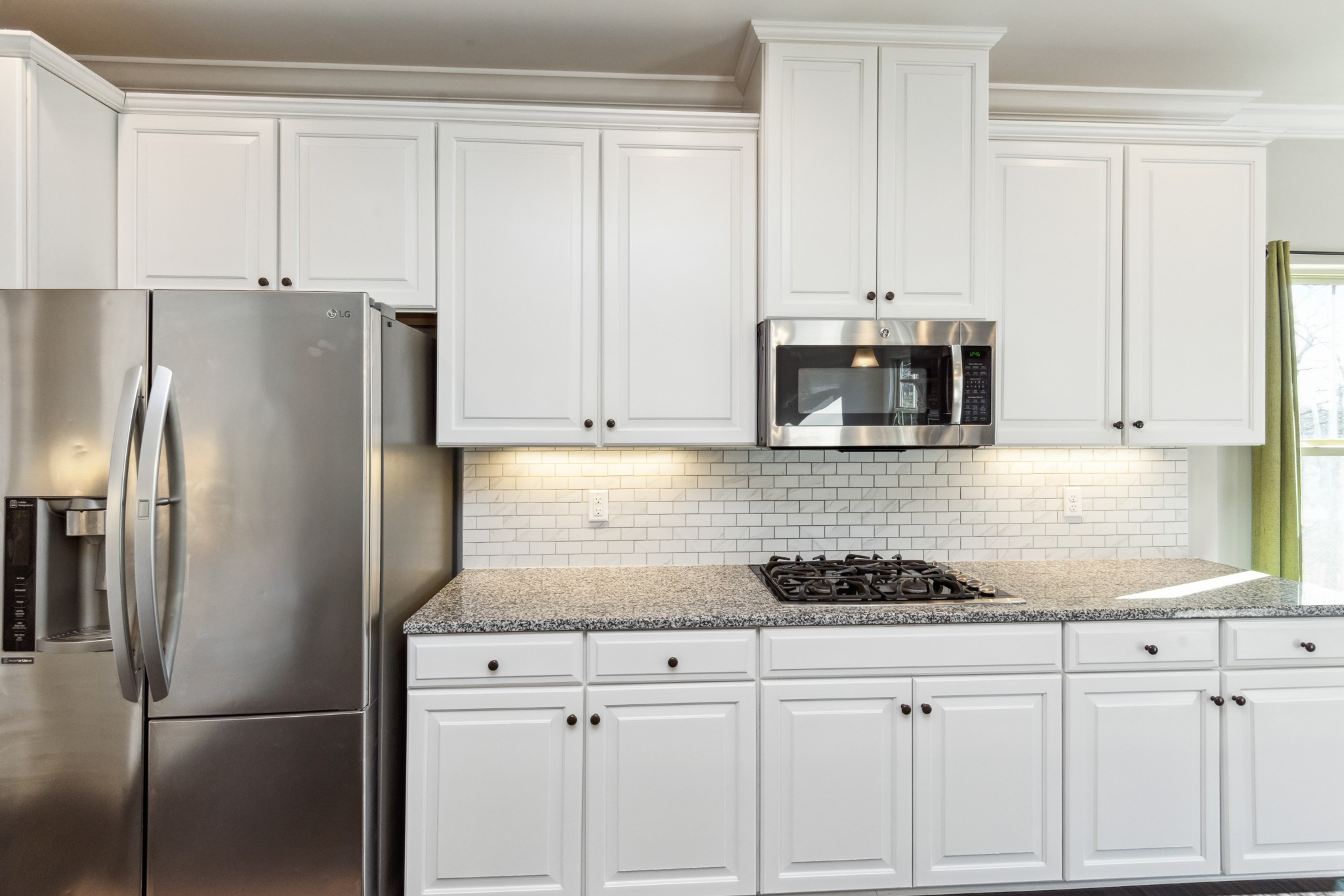 6820 Falls Ridge Lane College Grove, TN 37046 - Photo 9 of 46 a kitchen with granite countertop white cabinets and stainless steel appliances