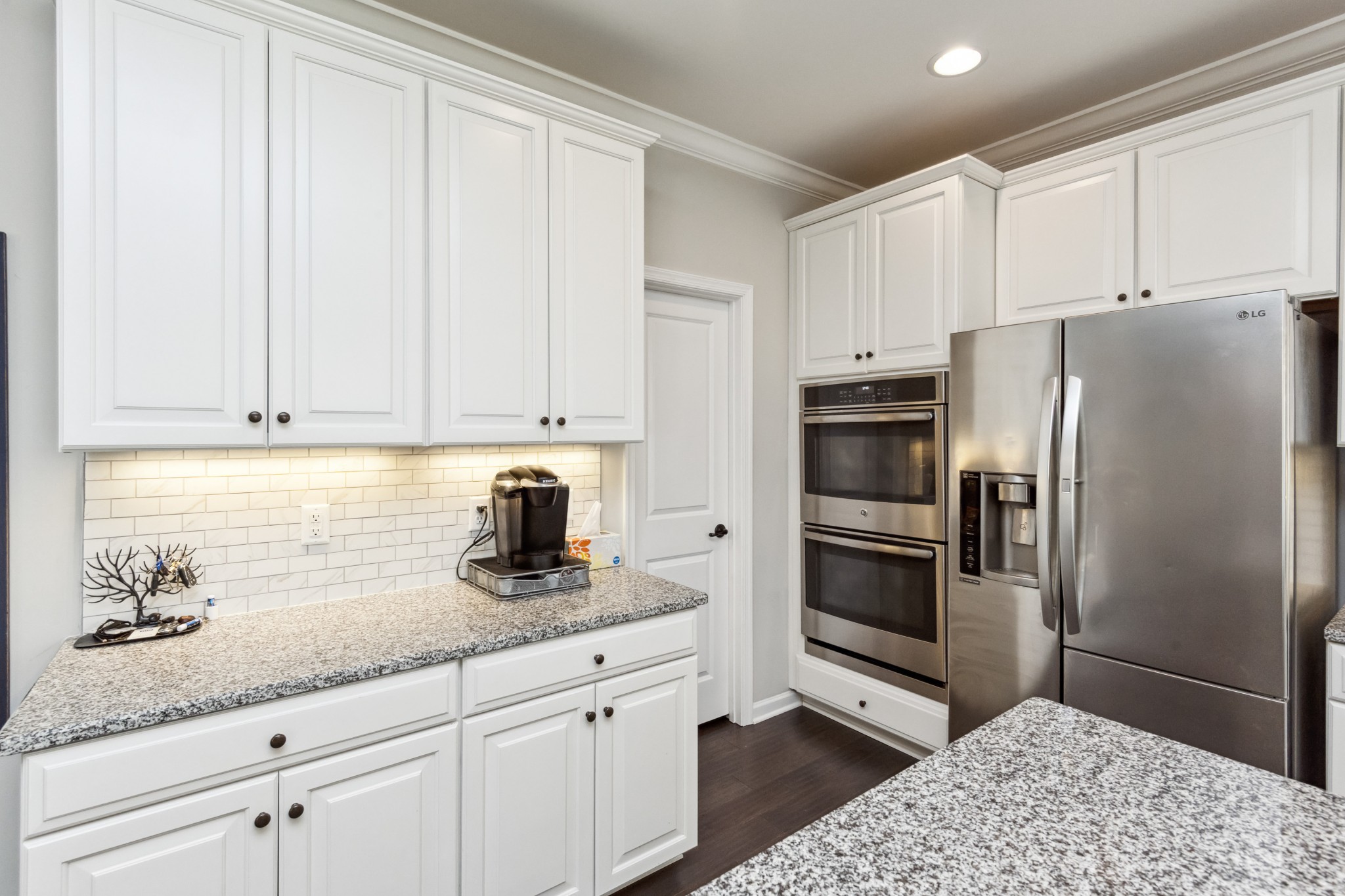 6820 Falls Ridge Lane College Grove, TN 37046 - Photo 10 of 46 a kitchen with granite countertop white cabinets and stainless steel appliances