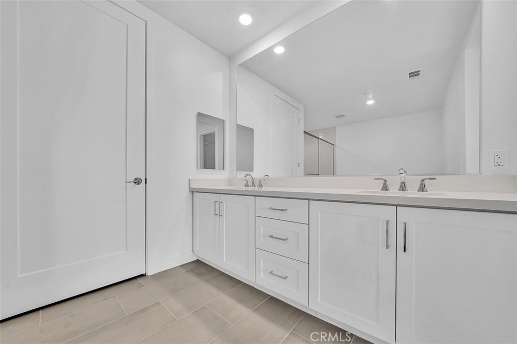 2708 Rivington Irvine, CA 92612 - Photo 11 of 24 a spacious bathroom with a double vanity sink and a mirror