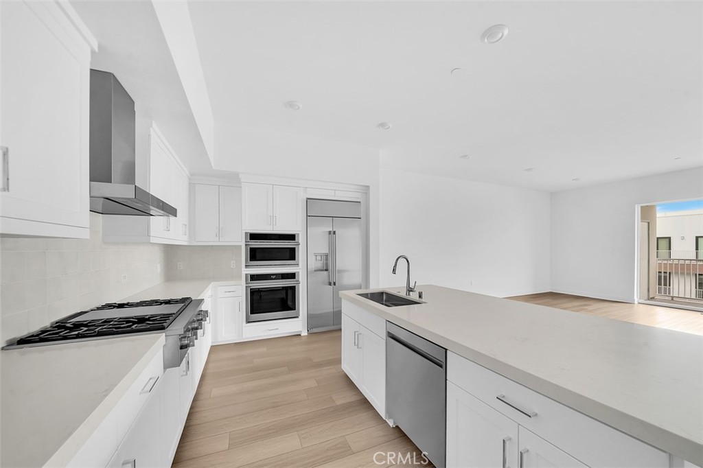 2708 Rivington Irvine, CA 92612 - Photo 3 of 24 a kitchen with stainless steel appliances a stove and a refrigerator