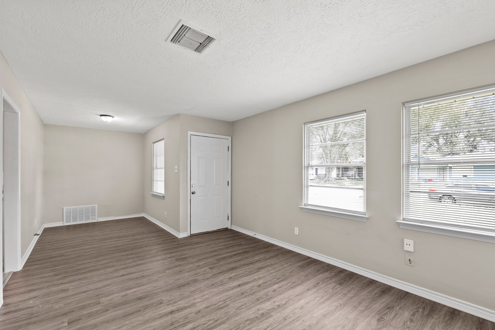 3206 Washington Street Pasadena, TX 77503 - Photo 2 of 12 a view of an empty room with wooden floor and a window