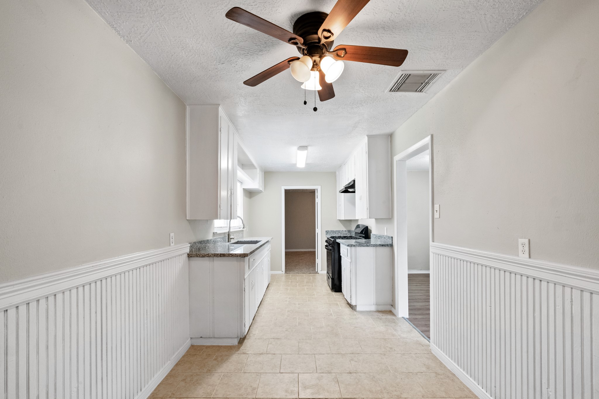 3206 Washington Street Pasadena, TX 77503 - Photo 5 of 12 a kitchen with stainless steel appliances kitchen island granite countertop a refrigerator and a sink