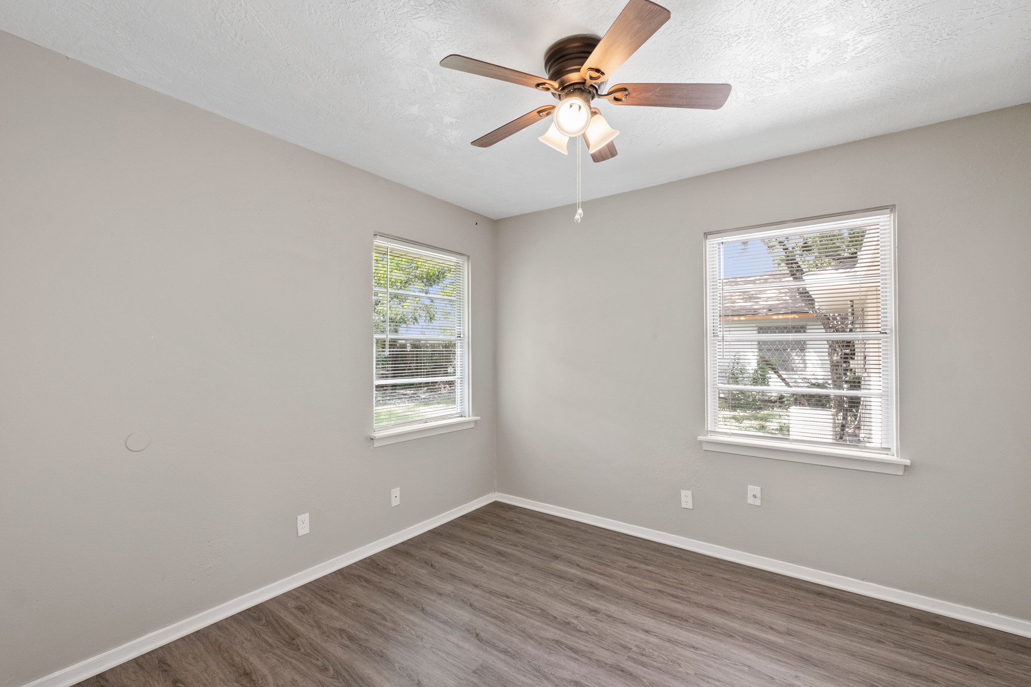 3206 Washington Street Pasadena, TX 77503 - Photo 7 of 12 a view of an empty room with a window and wooden floor
