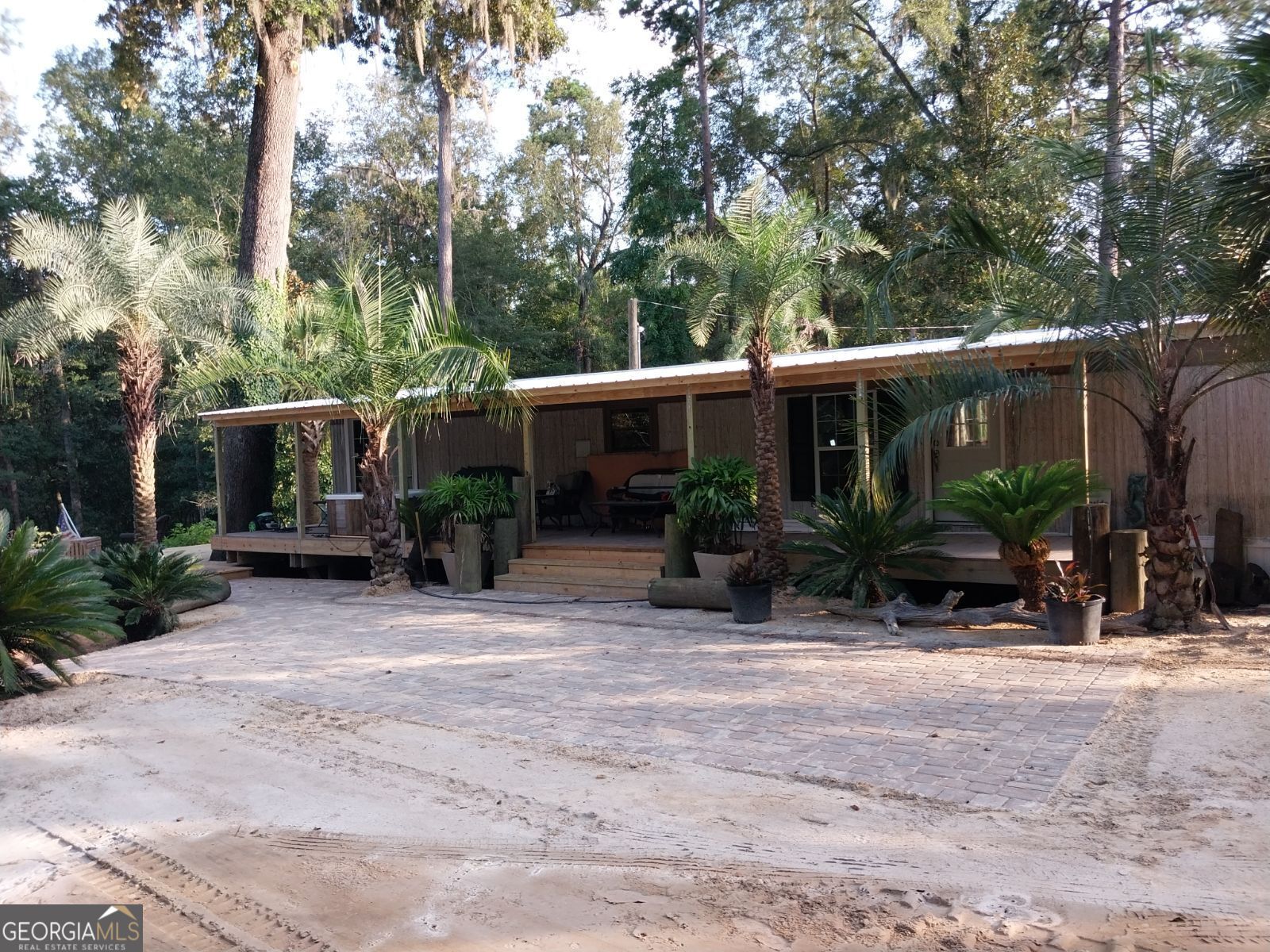 249 Holly Lane Rincon, GA 31326 - Photo 1 of 1 a view of house with outdoor seating and plants