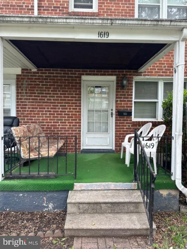 1619 Inverness Avenue Baltimore, MD 21230 - Photo 3 of 30 a front view of a house with a garden and trees