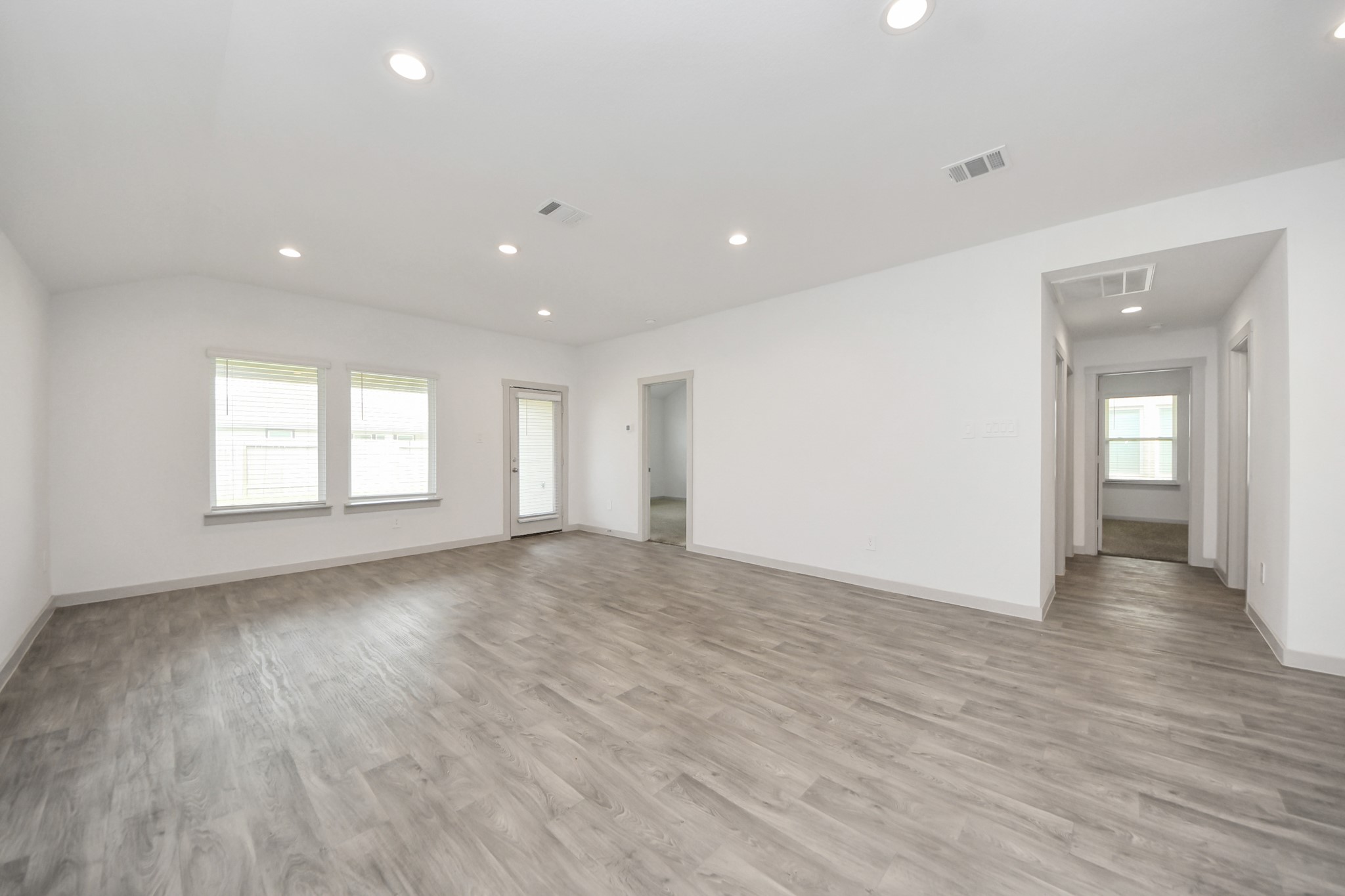 7806 Cattleman Vly Drive Rosharon, TX 77583 - Photo 17 of 40 a view of an empty room with wooden floor and a window