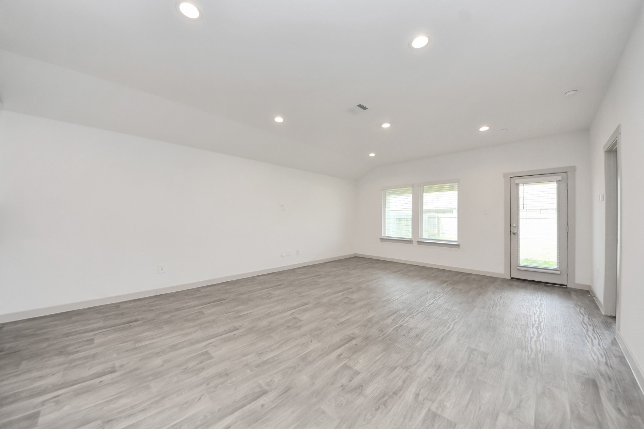 7806 Cattleman Vly Drive Rosharon, TX 77583 - Photo 18 of 40 an empty room with wooden floor and windows