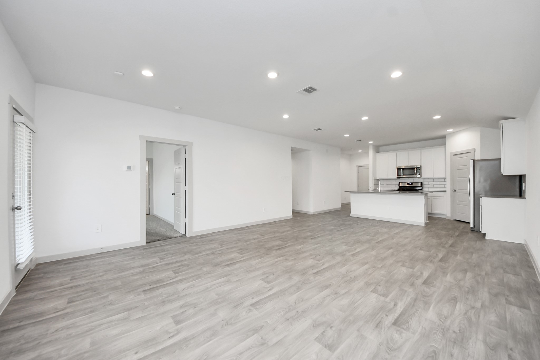 7806 Cattleman Vly Drive Rosharon, TX 77583 - Photo 19 of 40 a view of kitchen with kitchen island a sink wooden floor and a refrigerator in it